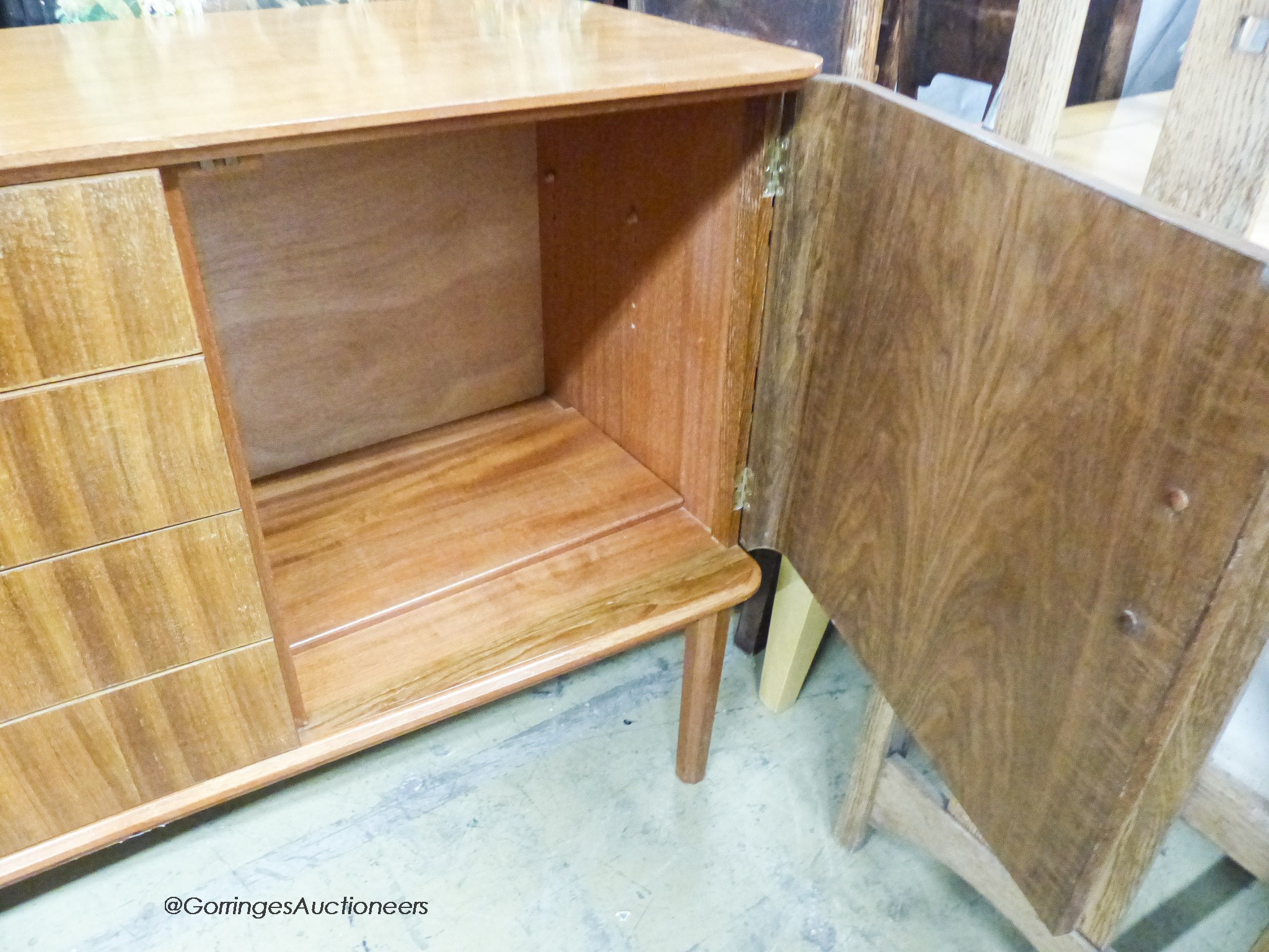 A Gordon Russell Ltd teak and Indian Laurel concave sideboard Model R810 circa 1960, length 183cm, depth 49cm, height 86cm